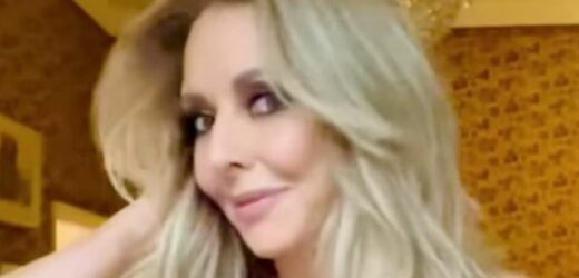 Carol Vorderman arches back in clingy dress as fans can’t stop watching