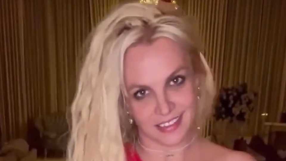 Britney Spears goes braless in dangerously cut-out scarlet dress for steamy video to Madonna song at LA mansion | The Sun